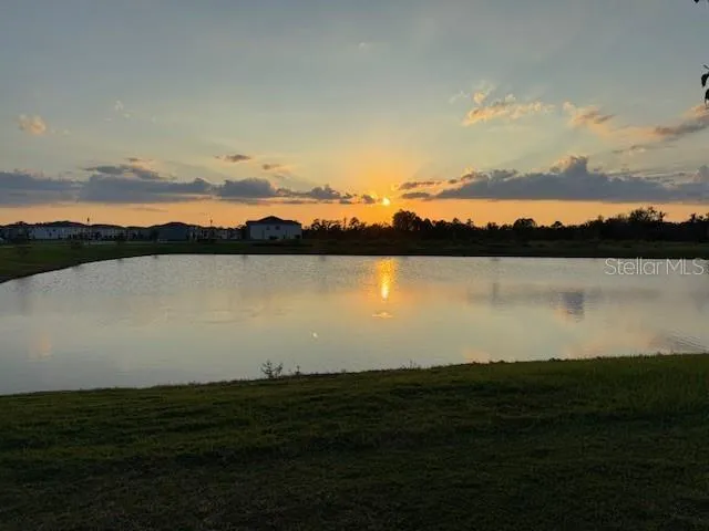 a kitchen with a refrigerator a microwave a sink and cabinets