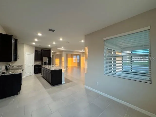a bathroom with a granite countertop tub sink and mirror