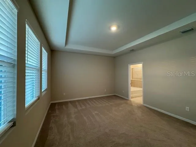 a bathroom with a tub sink shower and mirror