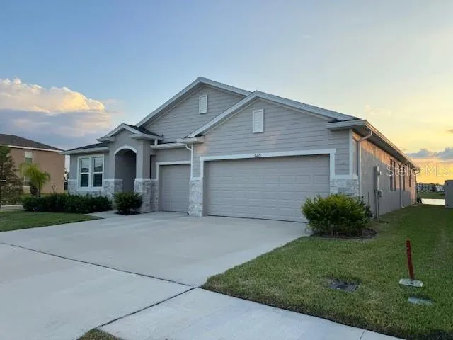 a front view of a house with a yard and garage