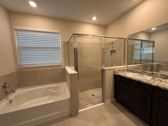 a view of kitchen with refrigerator and microwave