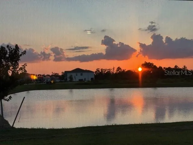 a view of a kitchen with a sink and a refrigerator