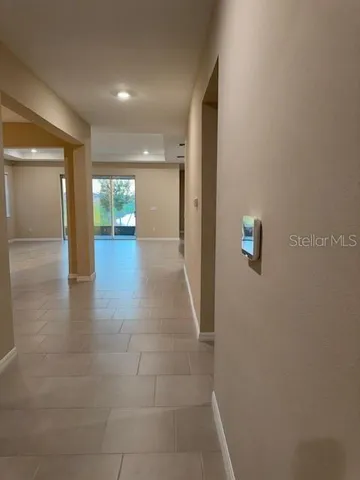 a view of an empty room and a window