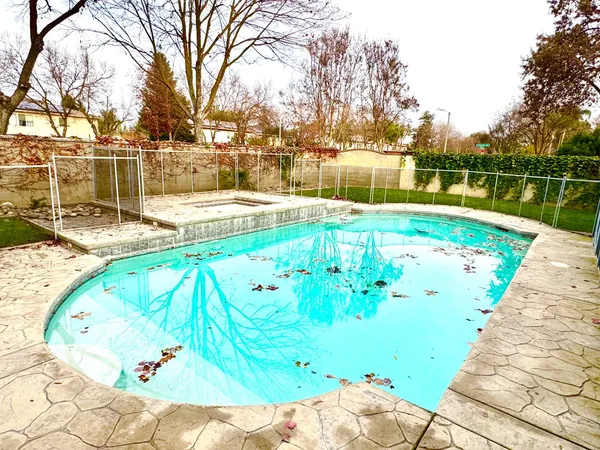 a view of a swimming pool with a yard