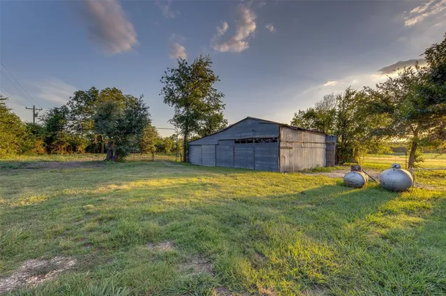 a view of backyard with outdoor space and car parked