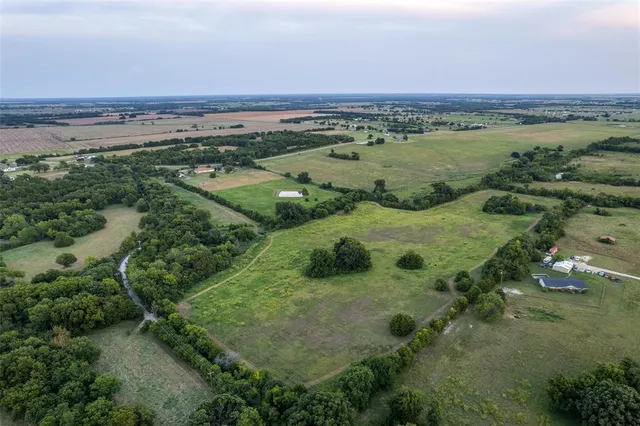 an aerial view of a forest with houses