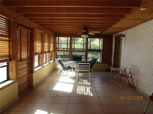 a view of a patio with table and chairs with wooden floor