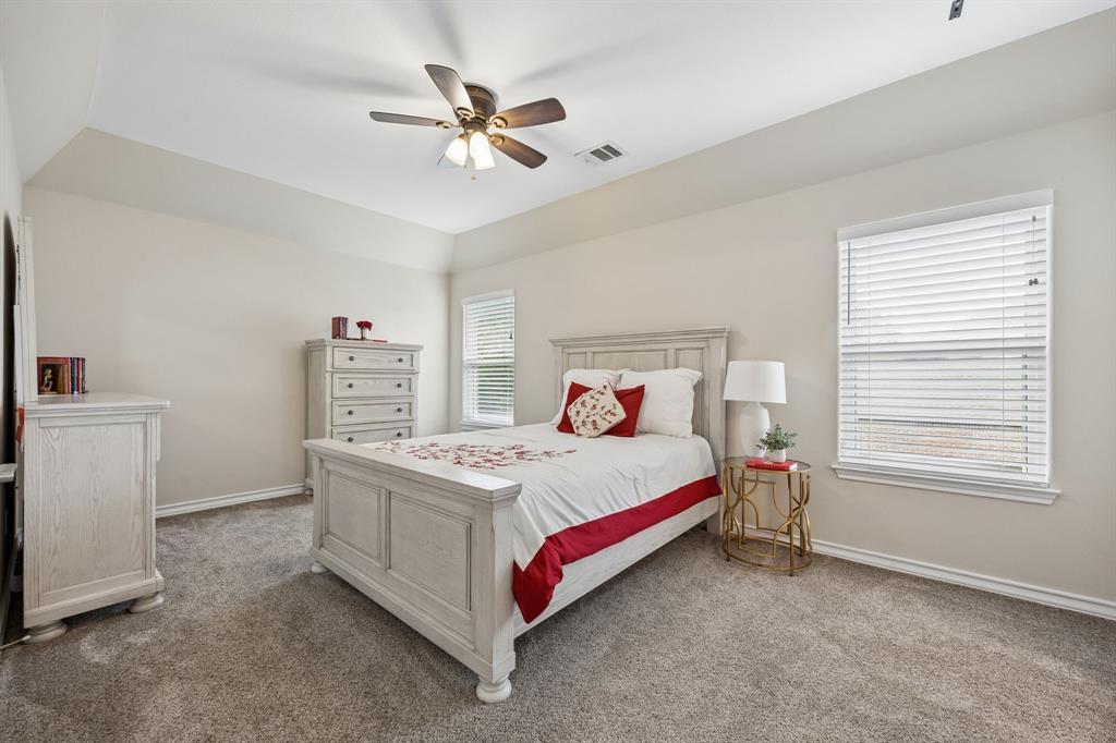 1011 Three Rivers Drive Prosper, TX 75078 - Photo 16 of 27 a bed sitting in a bedroom next to a window