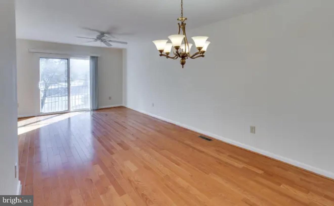 1707 Tyvale Court Vienna, VA 22182 - Photo 4 of 28 wooden floor in an empty room with a window