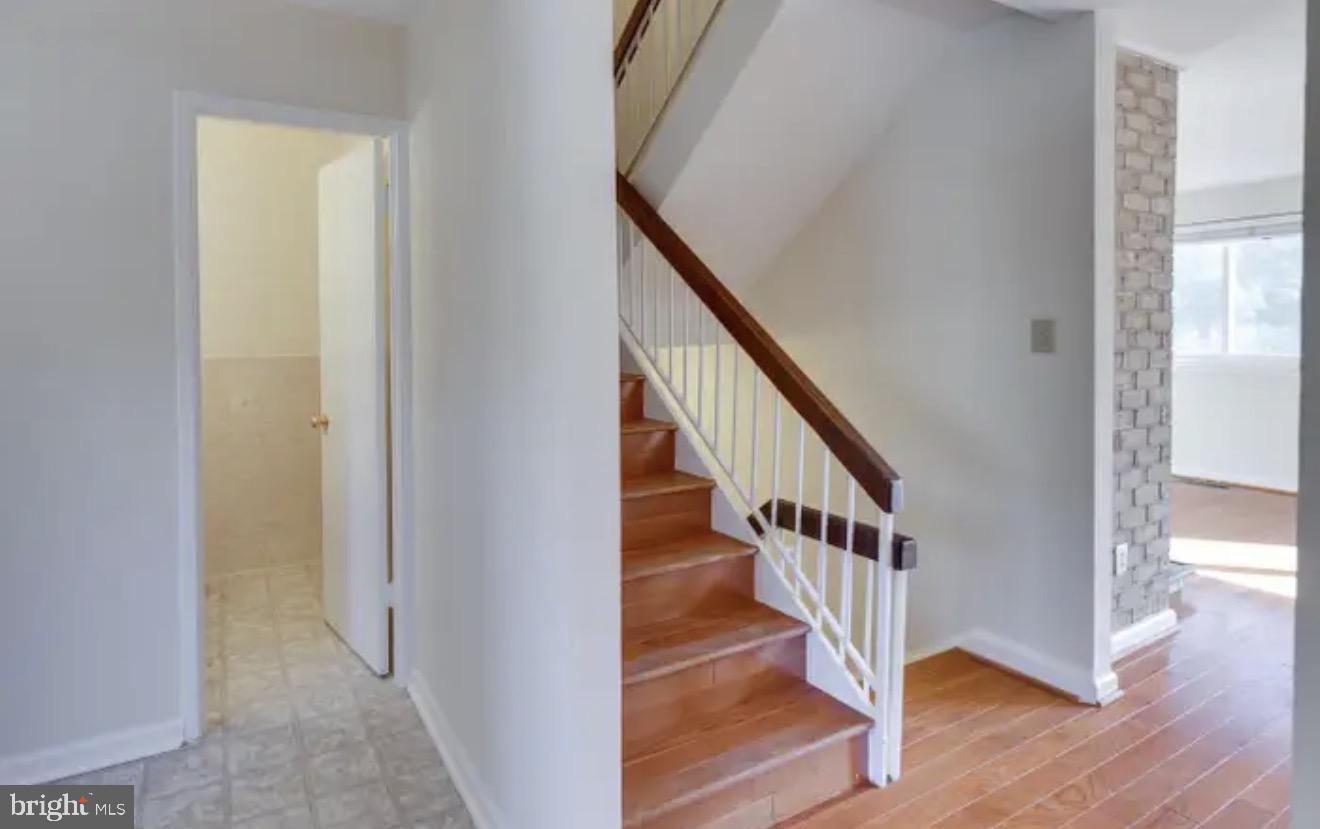 1707 Tyvale Court Vienna, VA 22182 - Photo 7 of 28 a view of entryway with wooden floor and stairs