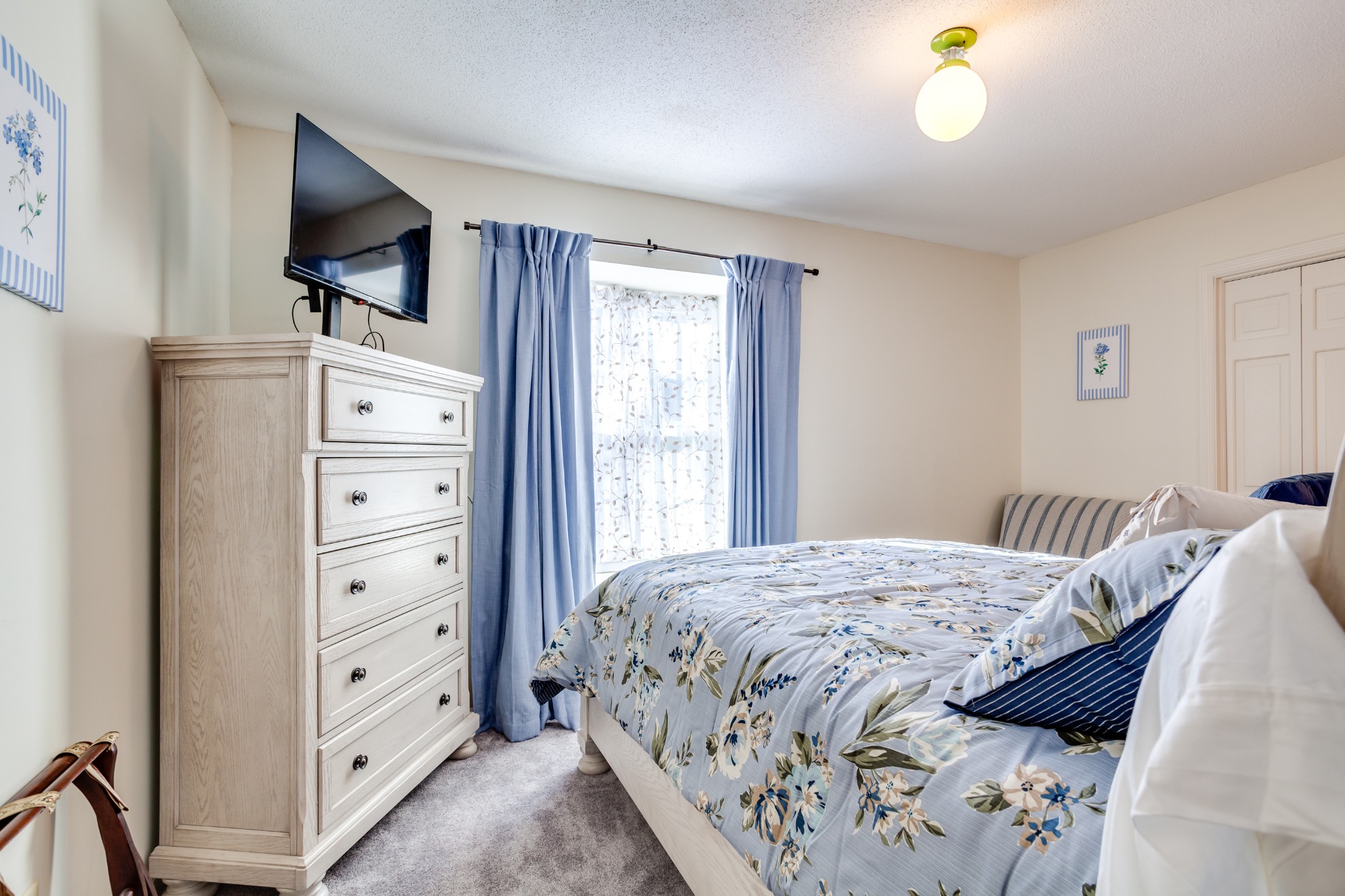 1434 Pine Springs Road Knoxville, TN 37922 - Photo 19 of 53 a bedroom with a bed and a flat tv screen on dresser
