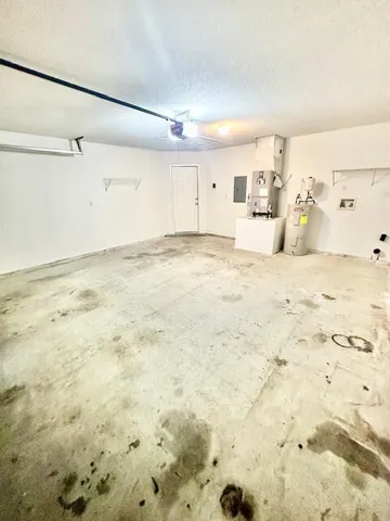 a view of empty room with wooden floor and fence