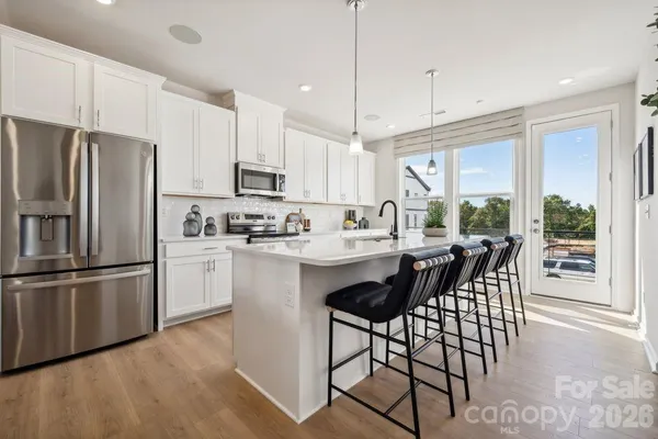 a kitchen with kitchen island a large counter top space appliances and cabinets