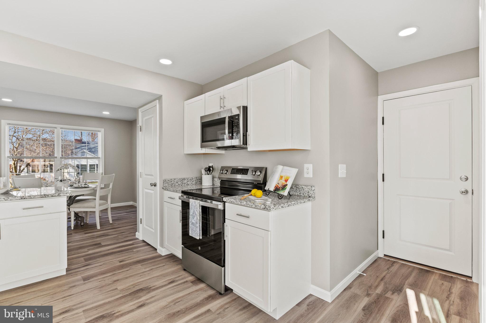 41573 Church Street Leonardtown, MD 20650 - Photo 12 of 27 a kitchen with a stove a sink and a microwave