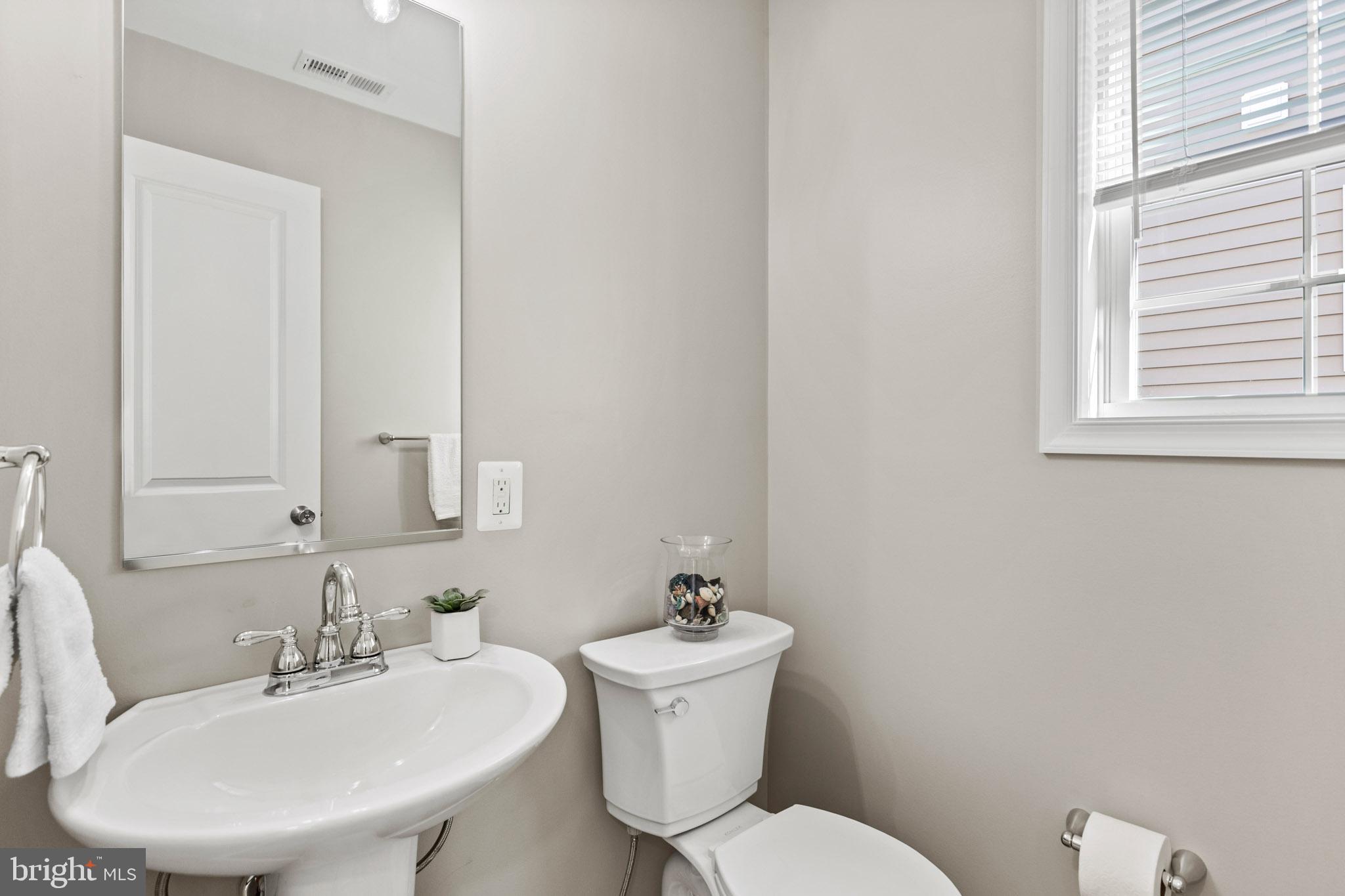 41573 Church Street Leonardtown, MD 20650 - Photo 13 of 27 a bathroom with a toilet a sink and mirror
