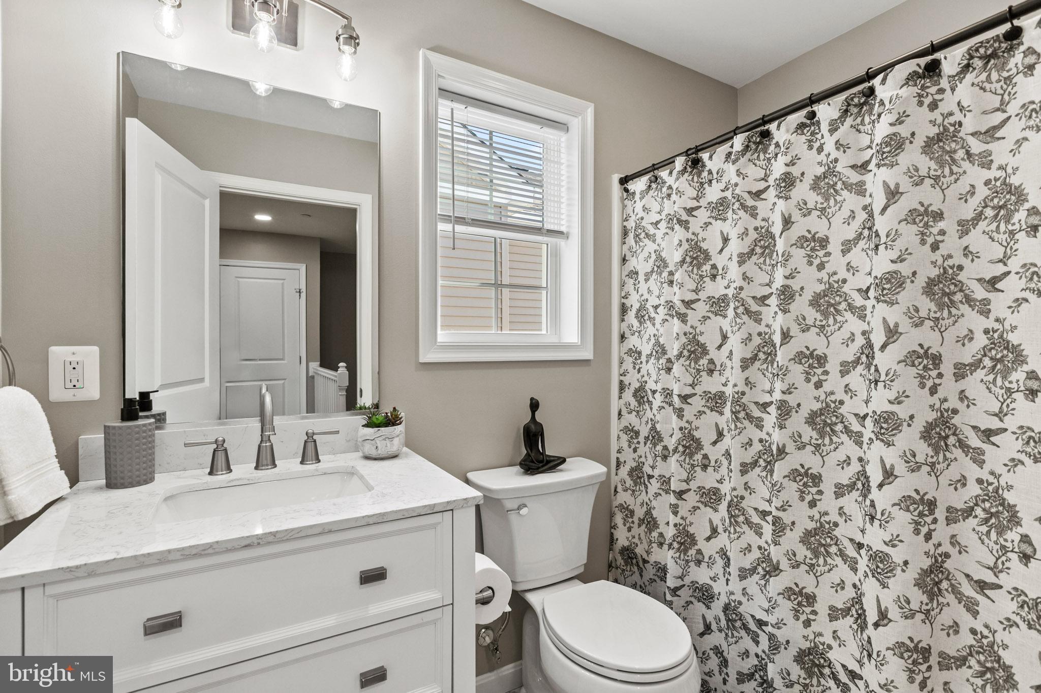 41573 Church Street Leonardtown, MD 20650 - Photo 22 of 27 a bathroom with a granite countertop toilet sink and mirror