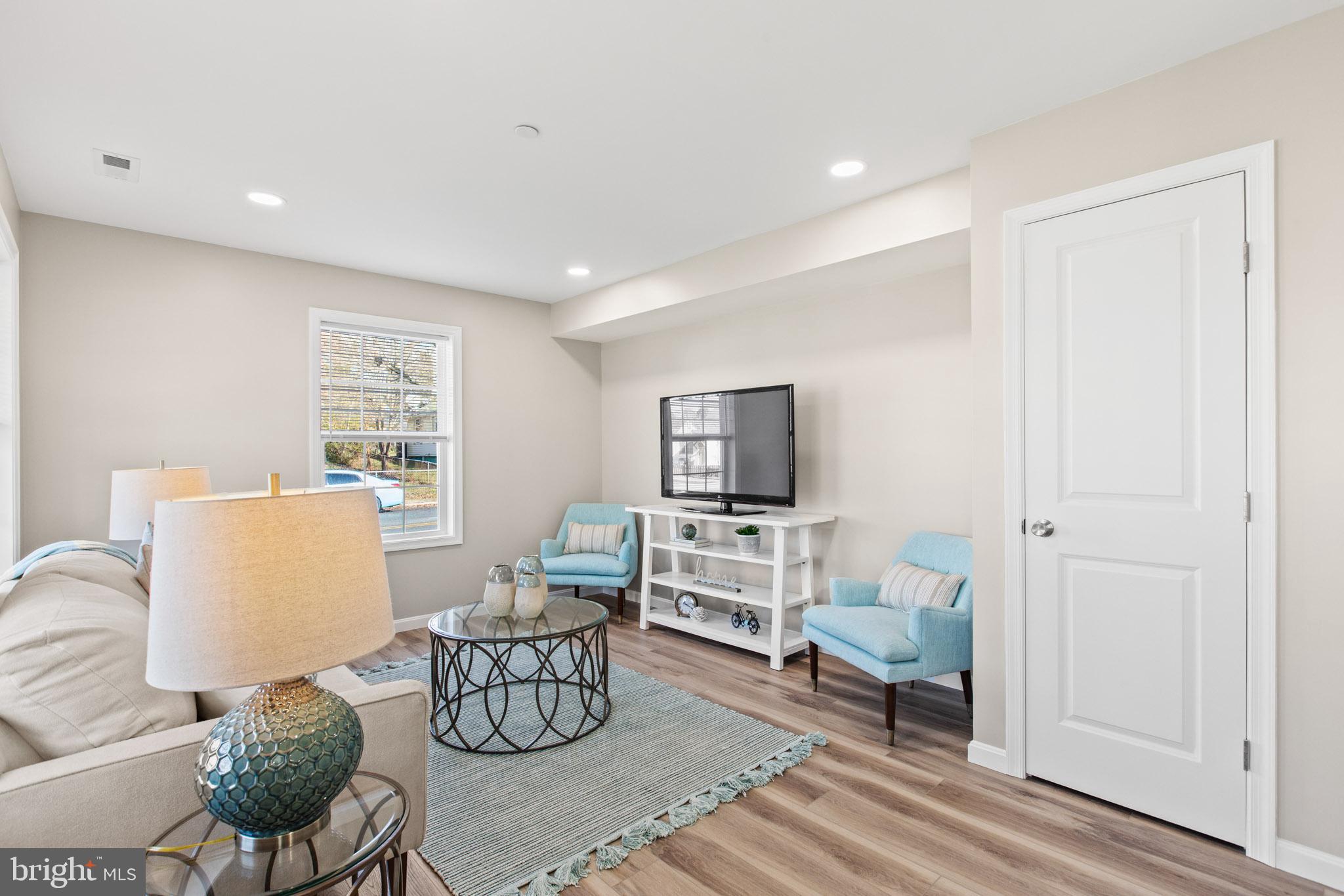41573 Church Street Leonardtown, MD 20650 - Photo 6 of 27 a living room with furniture and a flat screen tv