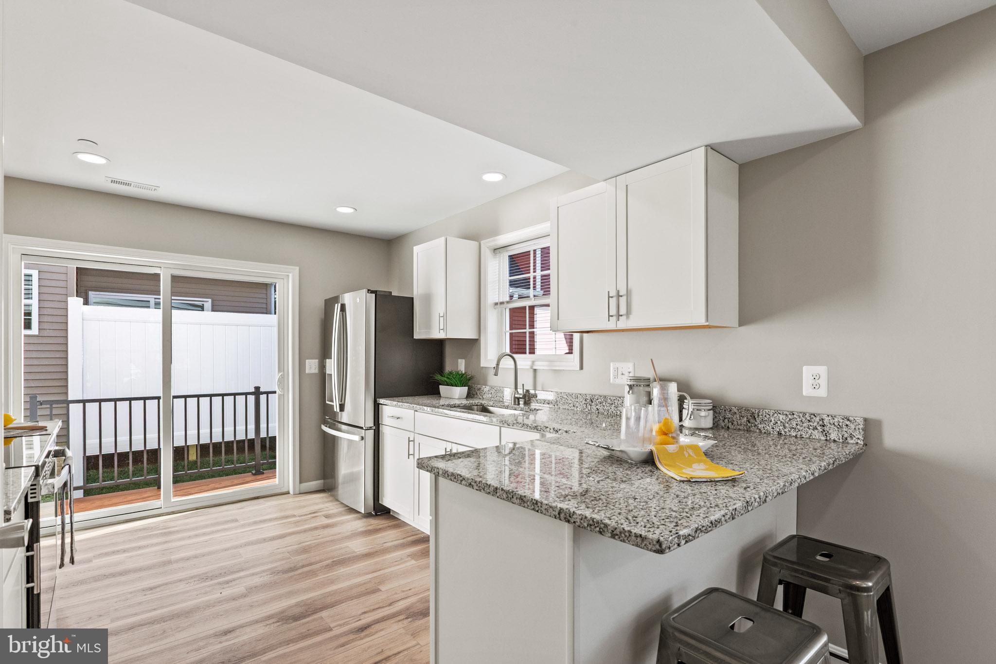 41573 Church Street Leonardtown, MD 20650 - Photo 10 of 27 a kitchen with a sink a stove and cabinets