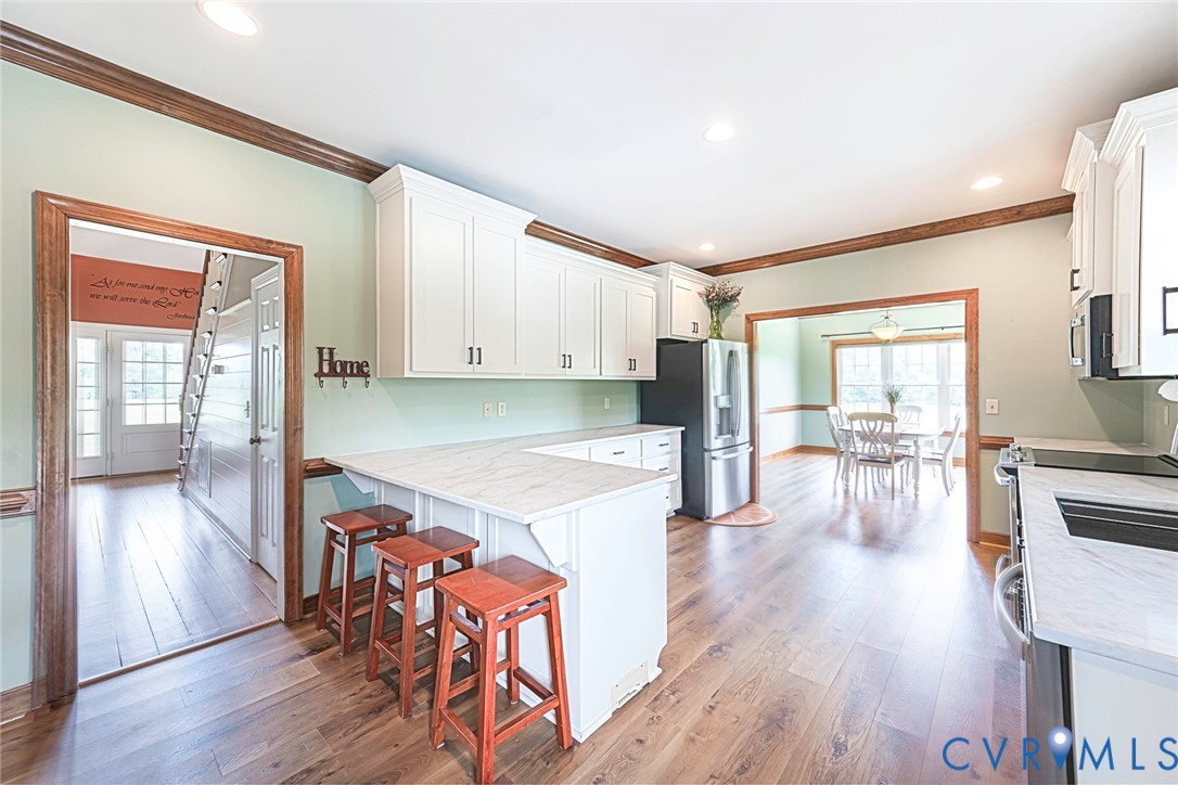 827 Sutherland Road Church Road, VA 23833 - Photo 15 of 51 Kitchen with wood-finish flooring, white cabinetry