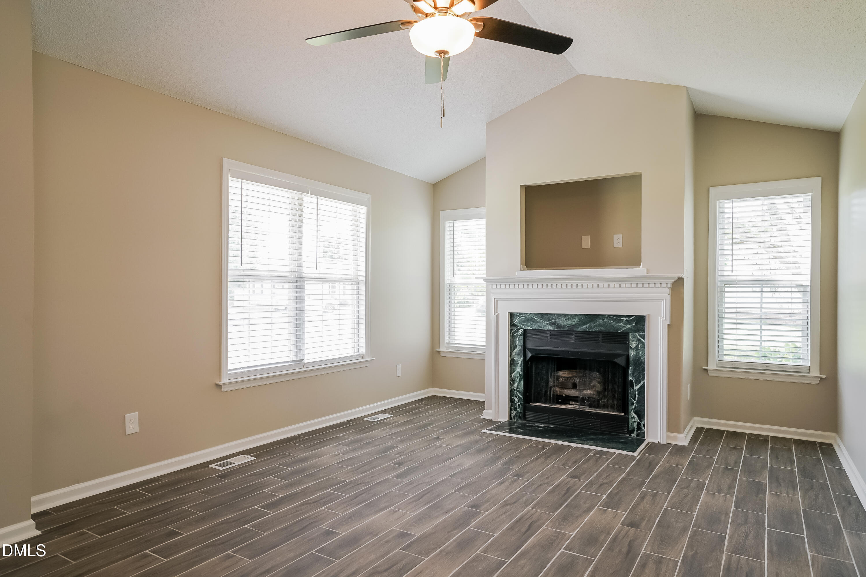 110 Impressive Lane Clayton, NC 27520 - Photo 3 of 16 a view of an empty room with wooden floor fireplace and a window