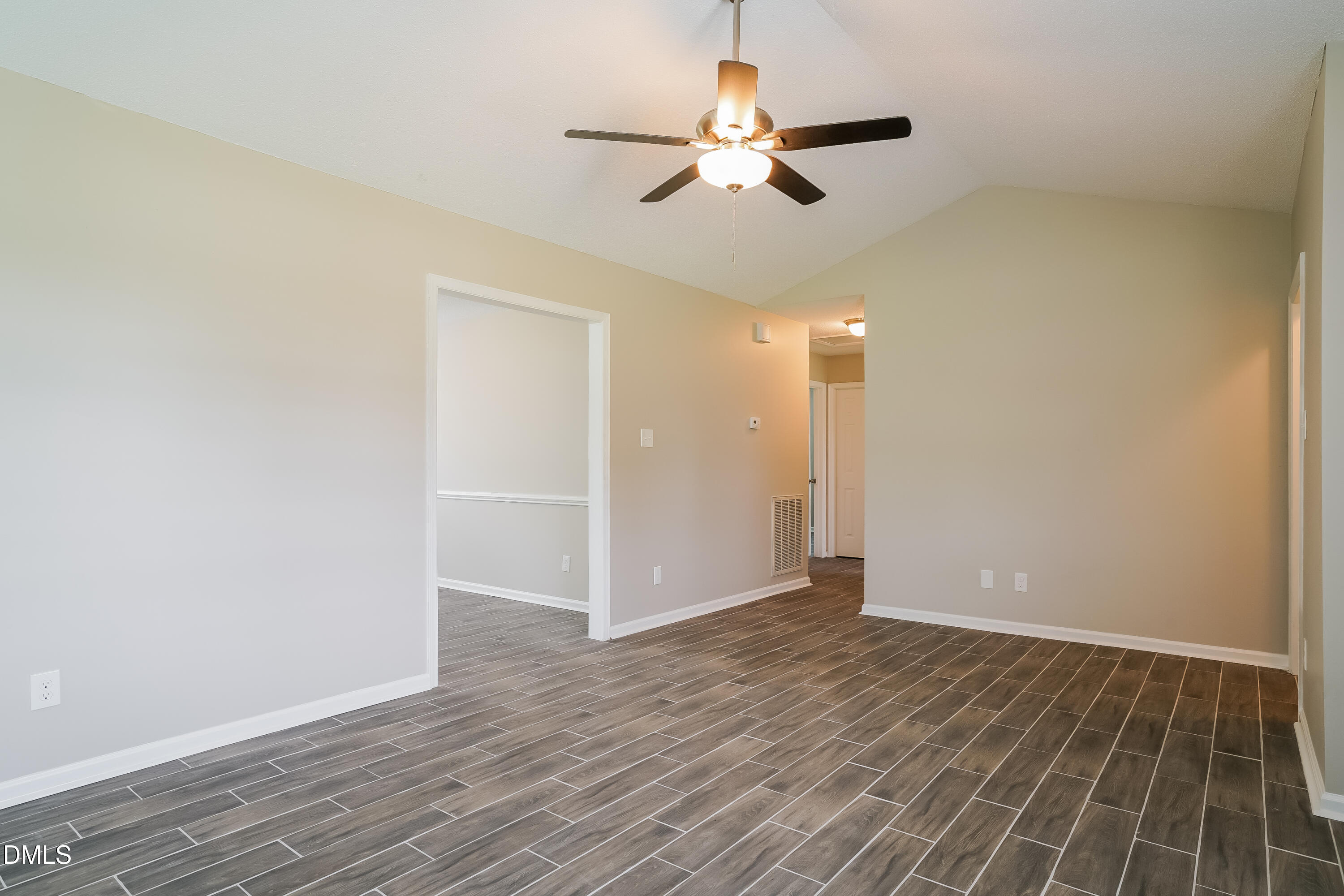 110 Impressive Lane Clayton, NC 27520 - Photo 4 of 16 an empty room with wooden floor fan and windows