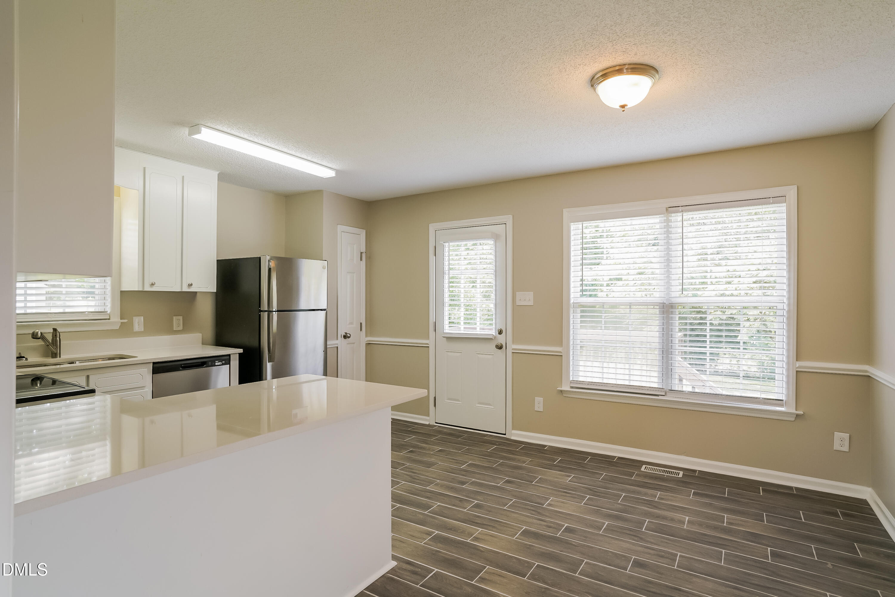 110 Impressive Lane Clayton, NC 27520 - Photo 5 of 16 a kitchen with stainless steel appliances a refrigerator and a stove top oven