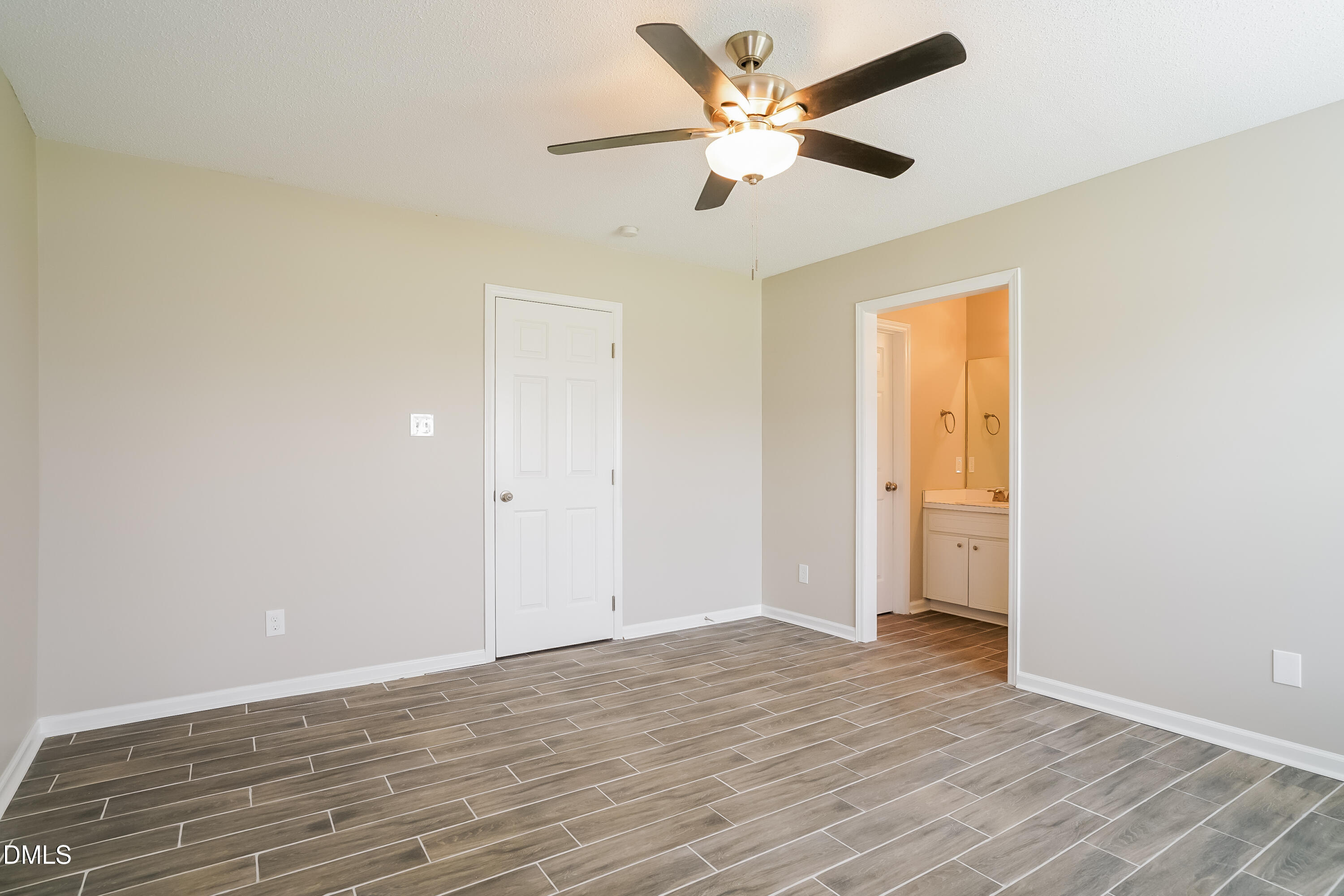 110 Impressive Lane Clayton, NC 27520 - Photo 8 of 16 an empty room with wooden floor and a ceiling fan