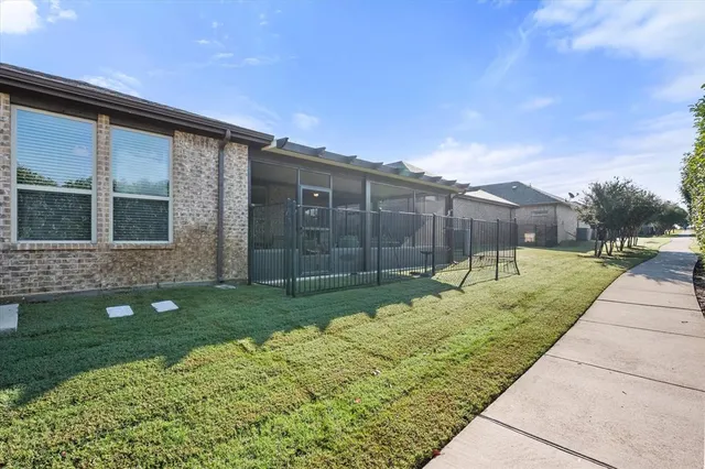 a view of a patio with lawn chairs next to a yard