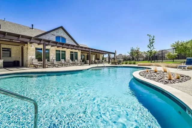 a view of a house with backyard and swimming pool
