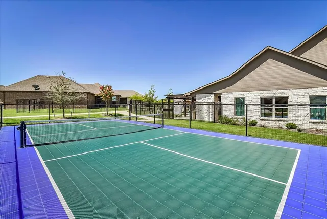 a front view of a house with a yard table and chairs