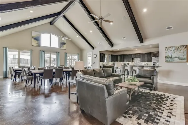 a living room with lots of furniture and a large window