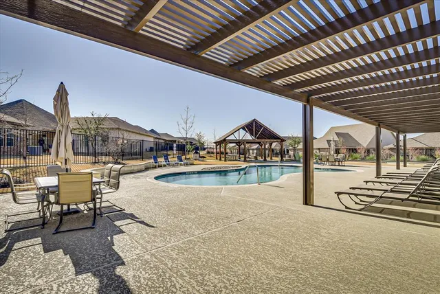 a building outdoor space with patio furniture and garden view