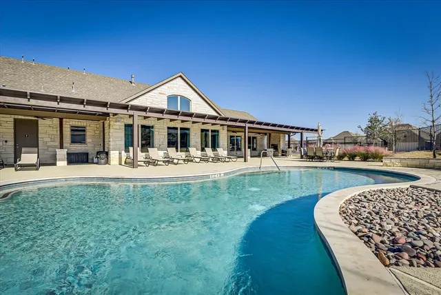 a view of swimming pool with outdoor seating
