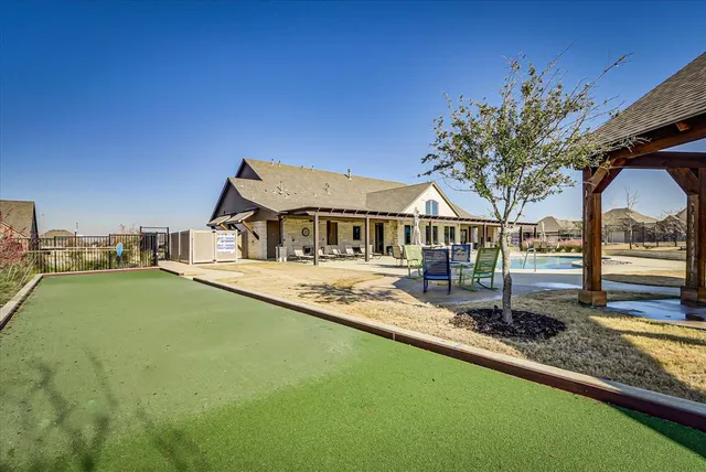 a view of house with swimming pool yard and outdoor seating