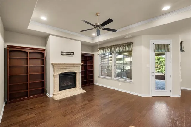 a view of an empty room with a fireplace and a window