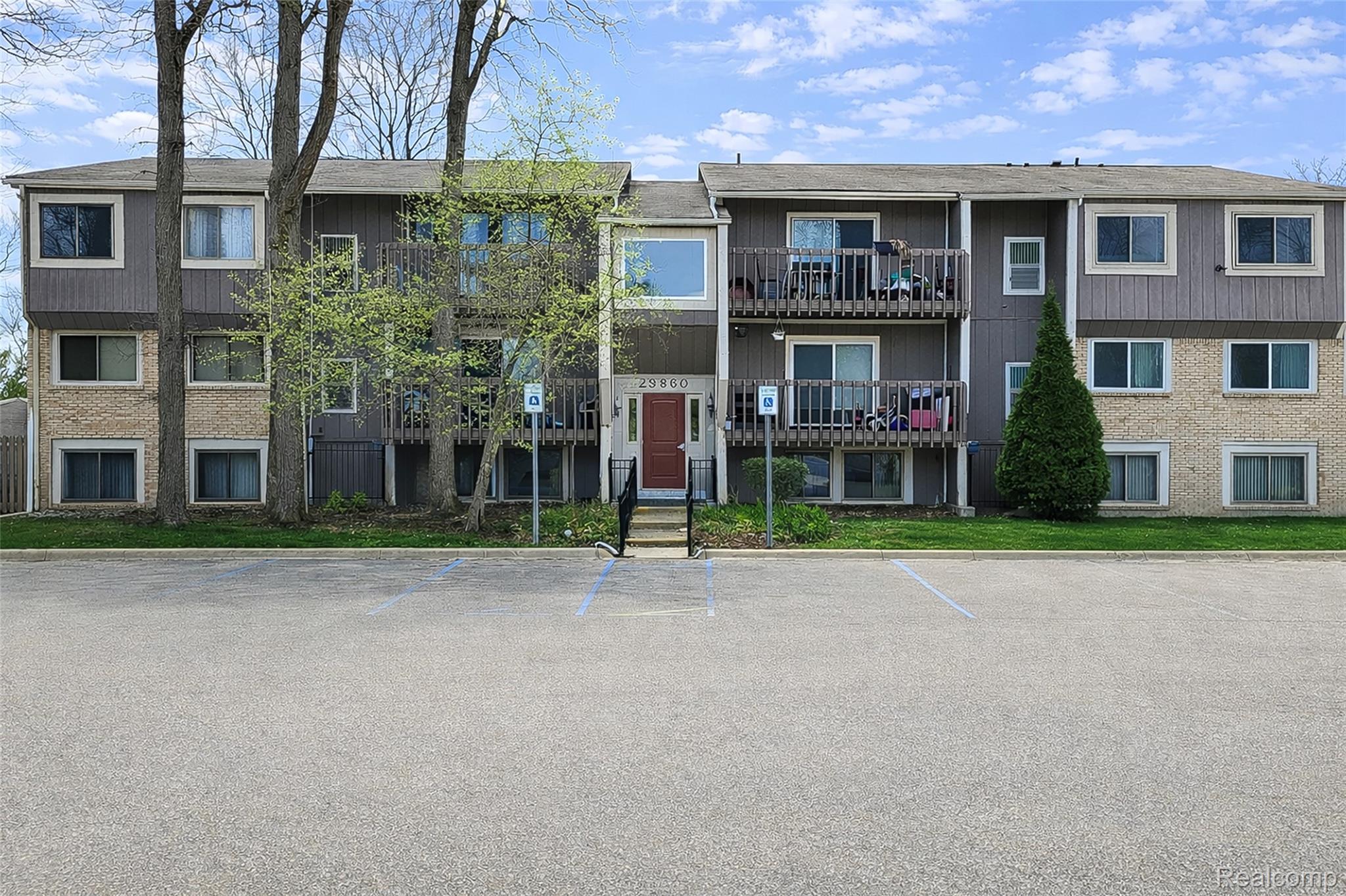 29860 West 12 Mile Road, Unit 604 Farmington, MI 48334 - Photo 2 of 26 View of apartment building / complex with uncovered parking