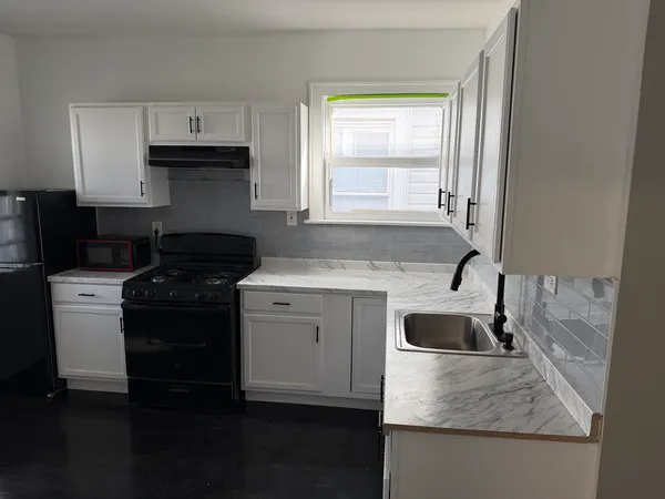 a kitchen with a sink stove and cabinets
