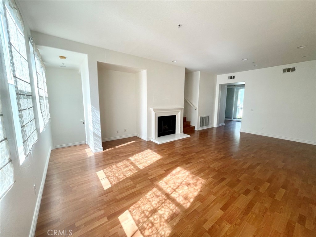 65 Passage Irvine, CA 92603 - Photo 11 of 28 a view of a livingroom with wooden floor and a fireplace