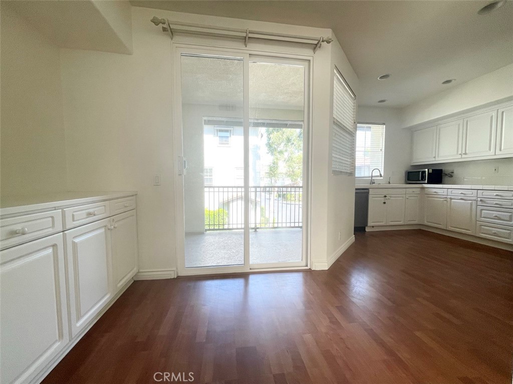 65 Passage Irvine, CA 92603 - Photo 18 of 28 a view of a kitchen with wooden floor and electronic appliances