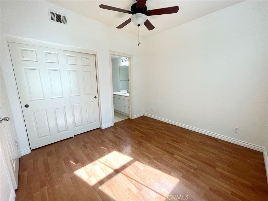 65 Passage Irvine, CA 92603 - Photo 6 of 28 a bedroom with a bed and a chandelier fan