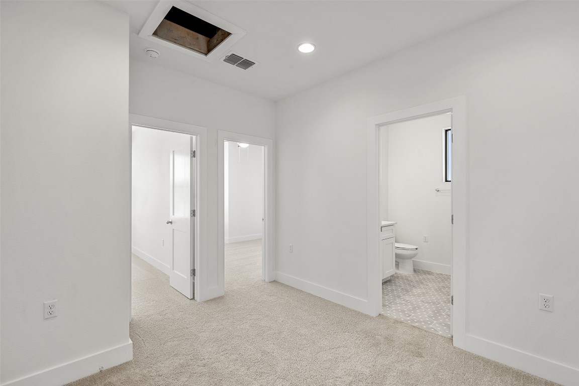 711 Paleface Ranch Road, Unit 3 Spicewood, TX 78669 - Photo 19 of 33 a bathroom with a toilet sink and a mirror