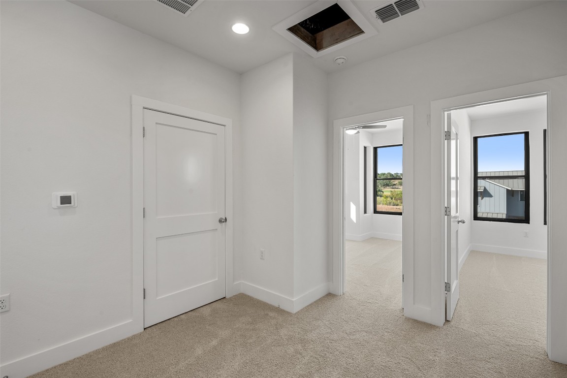 711 Paleface Ranch Road, Unit 3 Spicewood, TX 78669 - Photo 20 of 33 an empty room with windows and closet