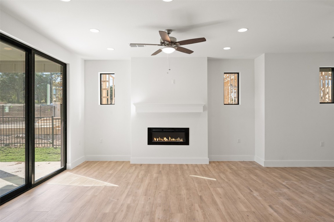 711 Paleface Ranch Road, Unit 3 Spicewood, TX 78669 - Photo 6 of 33 a view of a livingroom with a ceiling fan and window