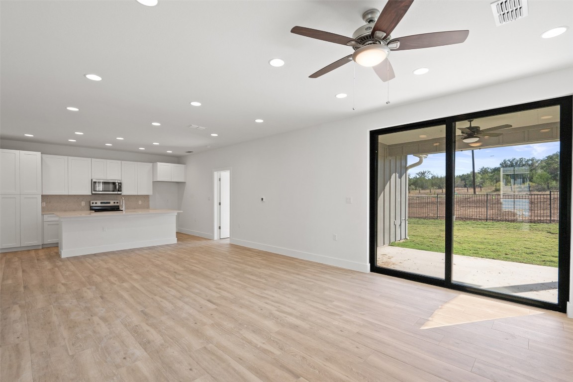 711 Paleface Ranch Road, Unit 3 Spicewood, TX 78669 - Photo 7 of 33 a view of kitchen with refrigerator and a ceiling fan