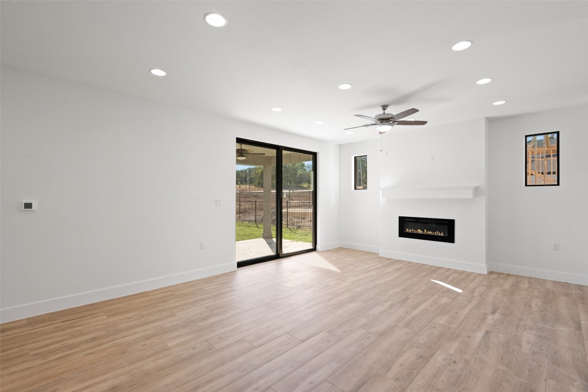 711 Paleface Ranch Road, Unit 3 Spicewood, TX 78669 - Photo 9 of 33 wooden floor in an empty room with a window