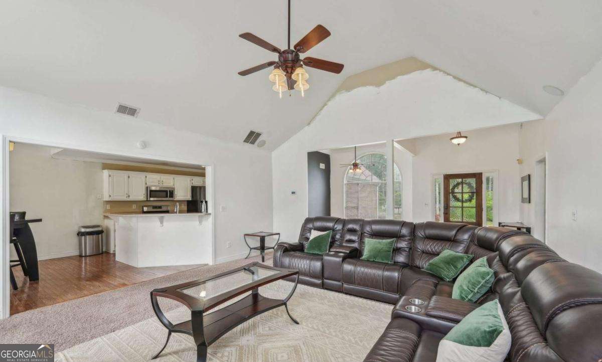 1535 Lake Dow Road McDonough, GA 30252 - Photo 3 of 9 a living room with furniture and kitchen view