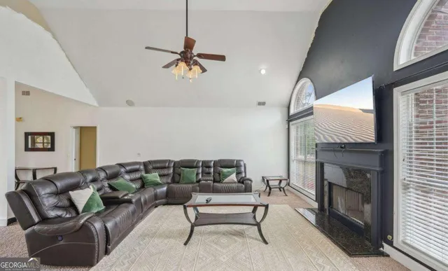a living room with furniture and a fireplace