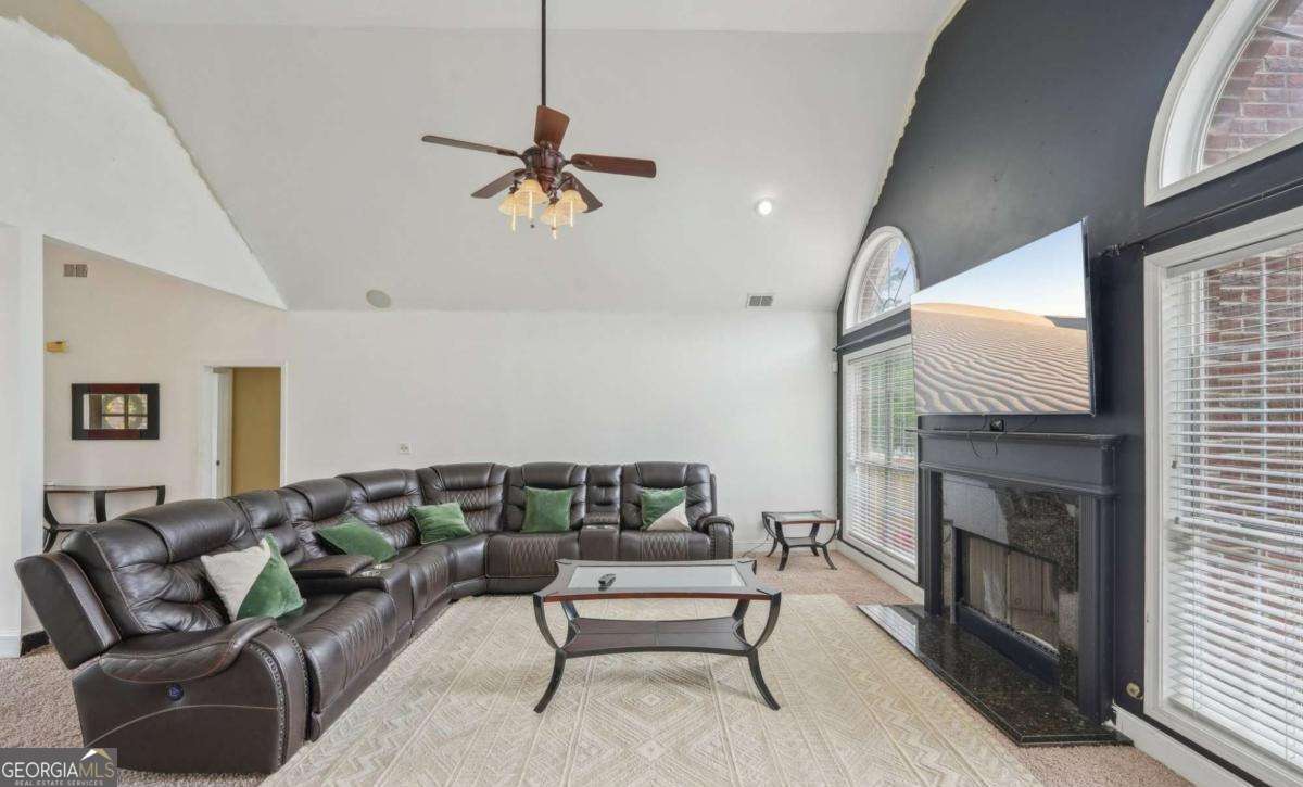 1535 Lake Dow Road McDonough, GA 30252 - Photo 4 of 9 a living room with furniture and a fireplace