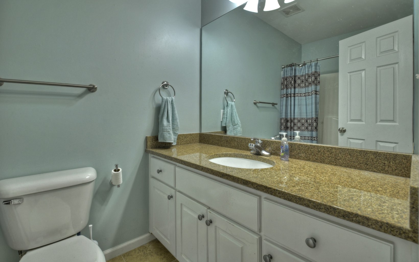 159 Meadowlark Lane Blue Ridge, GA 30513 - Photo 30 of 54 a bathroom with a granite countertop sink a toilet and a mirror