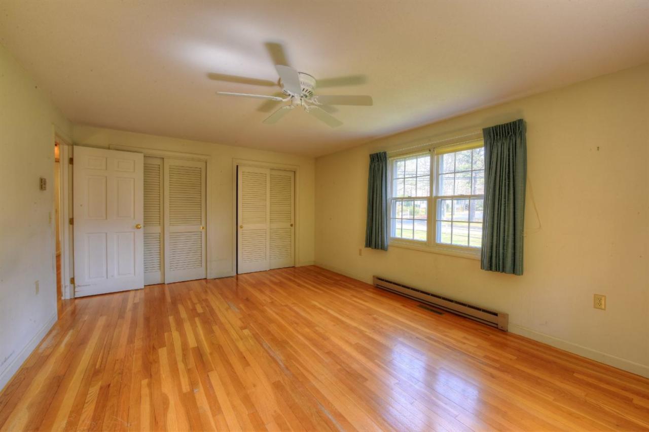 1394 Old Post Road Marstons Mills, MA 02648 - Photo 23 of 35 a view of an empty room with window and wooden floor